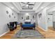 Spacious main bedroom featuring a tray ceiling, hardwood floors, fan, stylish decor, and en-suite bathroom at 3482 Atlanta St, Atlanta, GA 30337