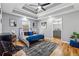 Spacious main bedroom featuring a tray ceiling, hardwood floors, fan, and en-suite bathroom at 3482 Atlanta St, Atlanta, GA 30337