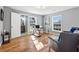 A bright office space with hardwood flooring, two windows, and comfortable seating at 3482 Atlanta St, Atlanta, GA 30337