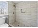 This bathroom features a modern tile shower with a built-in niche and a view from the window at 3482 Atlanta St, Atlanta, GA 30337