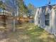 Spacious backyard featuring a grassy area and a border of mature trees at 7175 Bowie Dr, Lithonia, GA 30038