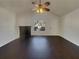 Bright living room with fireplace, ceiling fan, and hardwood floors at 7175 Bowie Dr, Lithonia, GA 30038