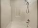 Shower tub features tile and updated shower head at 7175 Bowie Dr, Lithonia, GA 30038