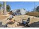 Private backyard featuring a fire pit with Adirondack chairs and a two-story house with deck access at 853 Gaston Sw St, Atlanta, GA 30310