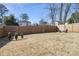 Spacious backyard featuring a wooden fence and a cozy fire pit area for relaxing at 853 Gaston Sw St, Atlanta, GA 30310