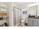 Bright bathroom with a vanity, patterned floor tiles, and a shower with curtain at 853 Gaston Sw St, Atlanta, GA 30310