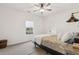 Minimalist bedroom with neutral tones, plush carpet, and a unique industrial-style wall lamp at 853 Gaston Sw St, Atlanta, GA 30310