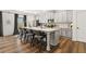 Modern kitchen with a large center island, bar stool seating, stainless appliances, and hardwood floors at 853 Gaston Sw St, Atlanta, GA 30310