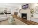 Open-concept living space featuring fireplace and hardwood flooring with a view to the kitchen at 853 Gaston Sw St, Atlanta, GA 30310