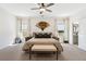 Spacious main bedroom featuring neutral tones, plush carpet, and a fan-shaped wall decor at 853 Gaston Sw St, Atlanta, GA 30310