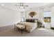 Bright main bedroom featuring neutral walls, plush carpet, and a decorative fan on the wall at 853 Gaston Sw St, Atlanta, GA 30310