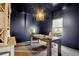 Modern home office with a large light wood desk, stylish light fixture, and neutral decor at 853 Gaston Sw St, Atlanta, GA 30310
