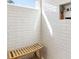 Modern shower with white tiled walls, window, and built-in bench, offering a spa-like experience at 853 Gaston Sw St, Atlanta, GA 30310