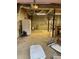 Unfinished basement with exposed ductwork, a white refrigerator, and a ladder at 15 Winterville Dr, Rockmart, GA 30153