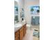 Bright bathroom featuring a wood vanity, granite countertop, and beach-themed decor at 15 Winterville Dr, Rockmart, GA 30153