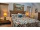 Cozy bedroom featuring a woven headboard, floral bedding, and warm lighting from bedside lamps at 15 Winterville Dr, Rockmart, GA 30153