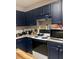 Functional kitchen with painted cabinets, modern appliances, ample counter space, and a decorative tile backsplash at 15 Winterville Dr, Rockmart, GA 30153