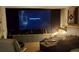Home theater room with a large screen, comfortable seating, and ambient lighting at 15 Winterville Dr, Rockmart, GA 30153