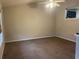 Neutral-toned living room with a ceiling fan, soft carpet, and a glimpse into the kitchen at 15 Winterville Dr, Rockmart, GA 30153