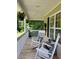 Inviting covered porch with rocking chairs, decorative pillows, and hanging plants, perfect for relaxation at 15 Winterville Dr, Rockmart, GA 30153