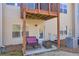 View of the back patio showcasing outdoor seating, small table, and access to the home's exterior at 2735 Kimblewick Ct, Cumming, GA 30040