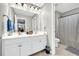 Bathroom featuring double sink vanity, large mirror, shower and neutral color scheme at 2735 Kimblewick Ct, Cumming, GA 30040