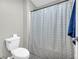 Bathroom with toilet, wood floors, updated vanity and shower curtain at 2735 Kimblewick Ct, Cumming, GA 30040