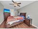 Comfortable bedroom with wood floors, ceiling fan, dresser, TV, and large windows at 2735 Kimblewick Ct, Cumming, GA 30040