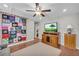 Relaxing bonus room featuring light gray walls, a TV, and rustic wood floors at 2735 Kimblewick Ct, Cumming, GA 30040