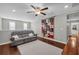 Open bonus room with dark wood floors and a comfortable gray sofa at 2735 Kimblewick Ct, Cumming, GA 30040