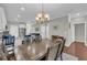 Dining room features modern chandelier lighting, wood floors, and neutral paint at 2735 Kimblewick Ct, Cumming, GA 30040