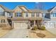 Charming townhome with a two-car garage, stone accents, and well-maintained landscaping at 2735 Kimblewick Ct, Cumming, GA 30040