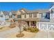 Charming townhome featuring a welcoming front porch and well-manicured landscaping at 2735 Kimblewick Ct, Cumming, GA 30040