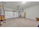 Spacious garage with epoxy flooring, garage door, and overhead lighting at 2735 Kimblewick Ct, Cumming, GA 30040