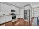 Bright kitchen with white cabinets, stainless steel appliances, and hardwood floors at 2735 Kimblewick Ct, Cumming, GA 30040