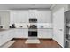 Modern kitchen featuring white cabinets, granite countertops, and stainless steel appliances at 2735 Kimblewick Ct, Cumming, GA 30040