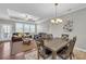 Open-concept living room featuring a tray ceiling, fan, and dining area at 2735 Kimblewick Ct, Cumming, GA 30040