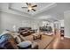 Open-concept living space with ample natural light, wood floors and comfortable seating at 2735 Kimblewick Ct, Cumming, GA 30040
