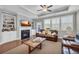 Cozy living room features a fireplace, built-in shelving, and a ceiling fan at 2735 Kimblewick Ct, Cumming, GA 30040