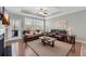 Spacious living room boasting tray ceilings, plenty of light, and a ceiling fan at 2735 Kimblewick Ct, Cumming, GA 30040