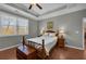 Bedroom featuring neutral paint, tray ceiling, wood floors, and a ceiling fan at 2735 Kimblewick Ct, Cumming, GA 30040