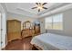 Bedroom features tray ceilings, hardwood floors, and a large window at 2735 Kimblewick Ct, Cumming, GA 30040
