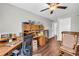 Spacious office with ample lighting, ceiling fan, wood floors, and custom cabinets/shelving at 2735 Kimblewick Ct, Cumming, GA 30040