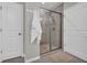 Modern bathroom with glass enclosed shower and neutral colored tiling at 2735 Kimblewick Ct, Cumming, GA 30040