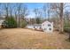 Expansive backyard featuring a wooden deck and mature trees, perfect for outdoor living at 291 Lamplighter Se Ln, Marietta, GA 30067