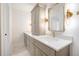 Bathroom with double sink vanity, gold fixtures, and marble floors at 291 Lamplighter Se Ln, Marietta, GA 30067