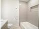 Bathroom featuring a shower and bath tub, tiled walls, and gold fixtures at 291 Lamplighter Se Ln, Marietta, GA 30067