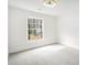 Bright bedroom with neutral carpet, ceiling fan, and window view at 291 Lamplighter Se Ln, Marietta, GA 30067