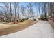 Long driveway leading to a house with well-maintained landscaping and mature trees at 291 Lamplighter Se Ln, Marietta, GA 30067