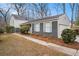 Charming home exterior featuring blue shutters, a gray brick foundation, and a manicured lawn at 291 Lamplighter Se Ln, Marietta, GA 30067